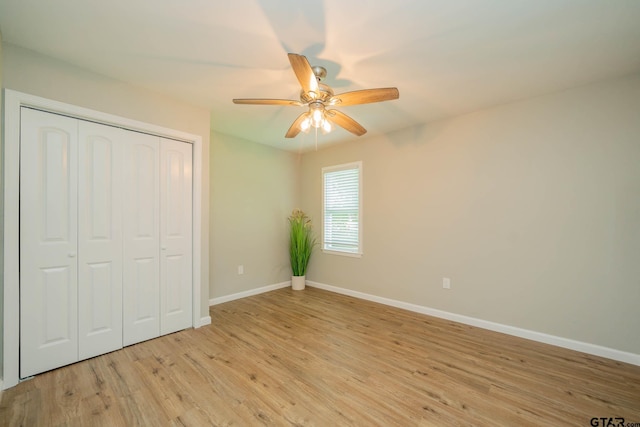 1021 N Montgomery St, Gilmer, TX 75644 - unfurnished bedroom featuring light wood-style flooring, a closet, and a ceiling fan