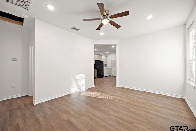 unfurnished room with wood finished floors, visible vents, and recessed lighting