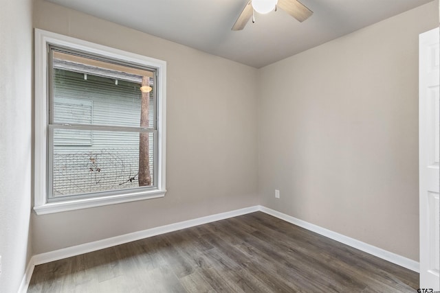 empty room with ceiling fan and dark hardwood / wood-style flooring