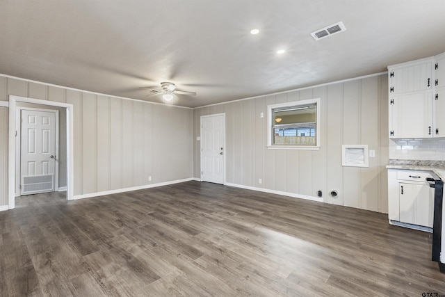 unfurnished living room featuring dark hardwood / wood-style floors and ceiling fan