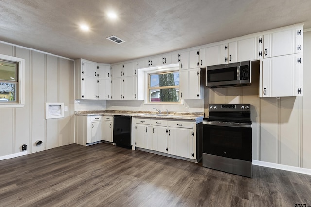 kitchen with white cabinetry, appliances with stainless steel finishes, sink, and dark hardwood / wood-style floors