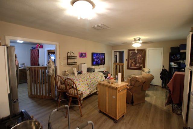 interior space with light wood-style flooring and freestanding refrigerator
