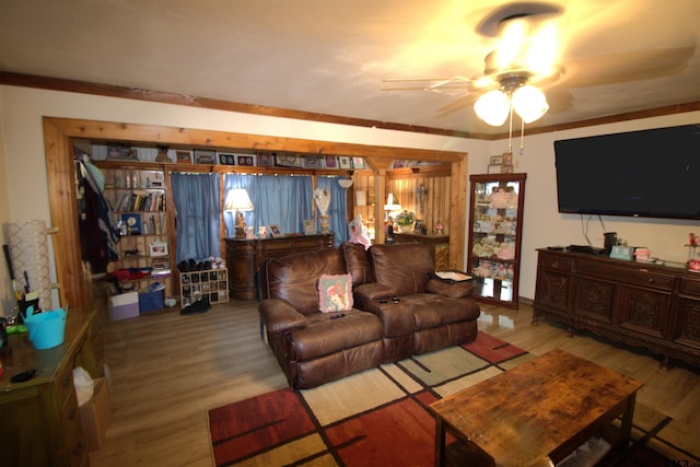 living room with a ceiling fan and wood finished floors