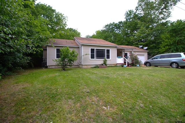 single story home with a front yard and a garage