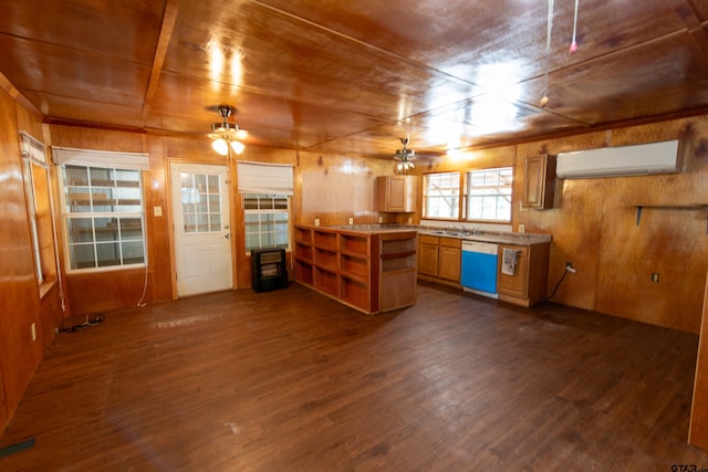 kitchen with wood walls, sink, dark hardwood / wood-style floors, an AC wall unit, and dishwasher