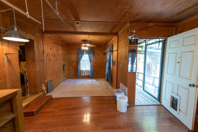 entryway with a wealth of natural light, wood-type flooring, wooden walls, and wood ceiling