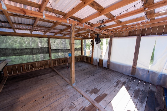 unfurnished sunroom with lofted ceiling with beams