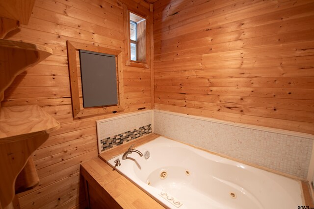 bathroom with wooden walls and a bathing tub