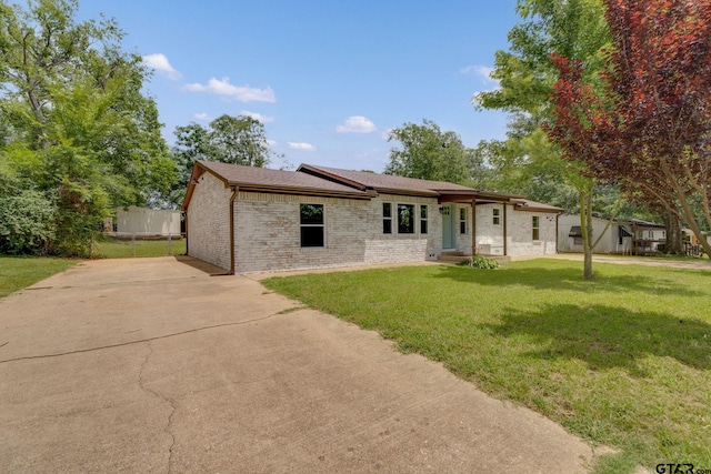 304 Hanks St, Whitehouse, TX 75791 - view of front of property with brick siding, a front yard, concrete driveway, and a shingled roof
