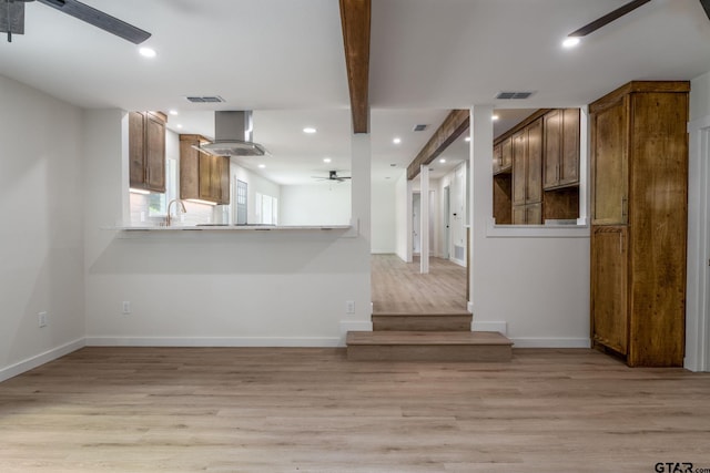 304 Hanks St, Whitehouse, TX 75791 - kitchen featuring ceiling fan, wall chimney exhaust hood, light wood-style floors, recessed lighting, and a peninsula