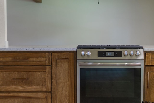 304 Hanks St, Whitehouse, TX 75791 - kitchen view of stainless steel gas stove, light countertops, and brown cabinetry