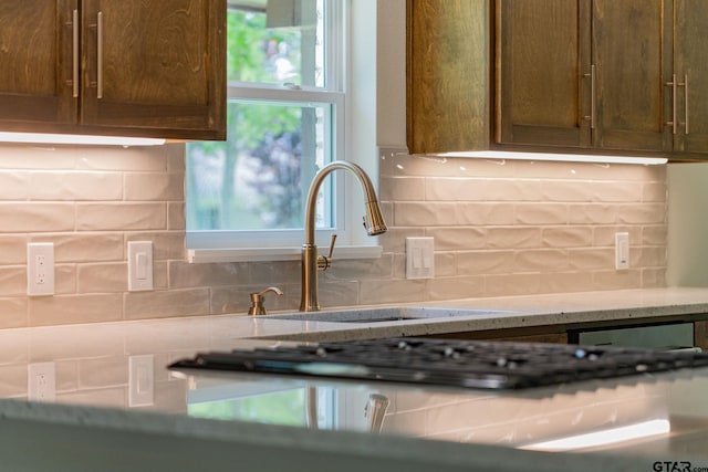 304 Hanks St, Whitehouse, TX 75791 - kitchen featuring backsplash and light stone counters