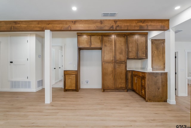 304 Hanks St, Whitehouse, TX 75791 - kitchen featuring brown cabinetry, light wood finished floors, recessed lighting, and light countertops