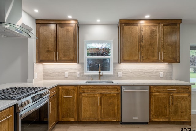 304 Hanks St, Whitehouse, TX 75791 - kitchen with stainless steel appliances, wall chimney exhaust hood, light wood-style floors, light stone counters, and decorative backsplash