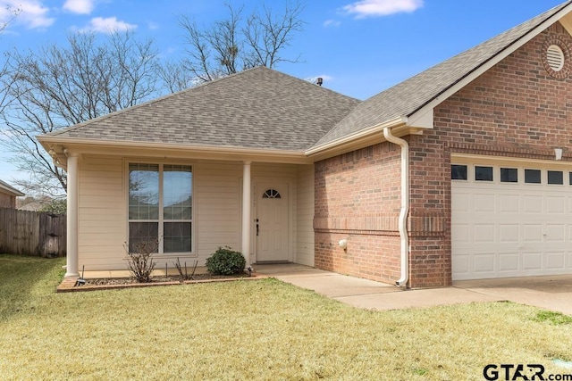 ranch-style home featuring a shingled roof, brick siding, an attached garage, and a front lawn