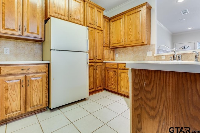 kitchen featuring visible vents, light tile patterned flooring, light countertops, and freestanding refrigerator