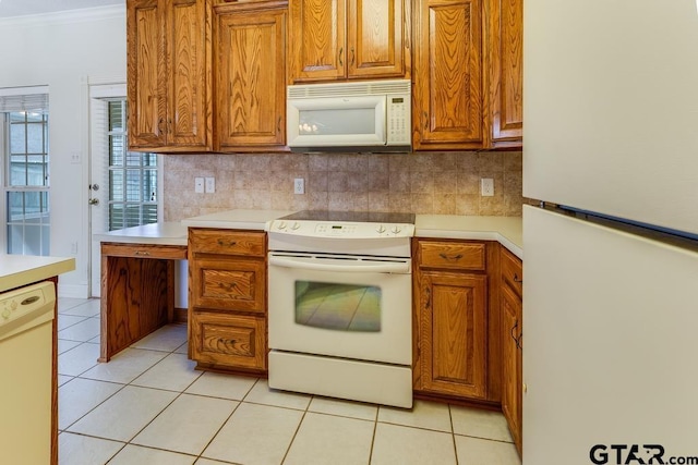 3425 Iberville Dr, Tyler, TX 75701 - kitchen featuring white appliances, light countertops, brown cabinets, and light tile patterned floors