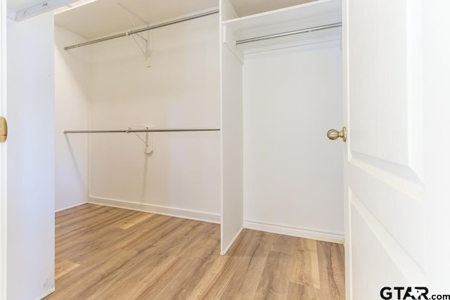 spacious closet with wood finished floors