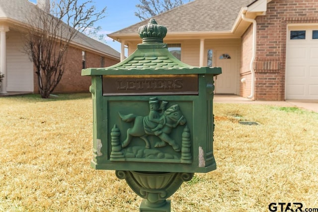 details with a downspout, gutters, brick siding, and a shingled roof