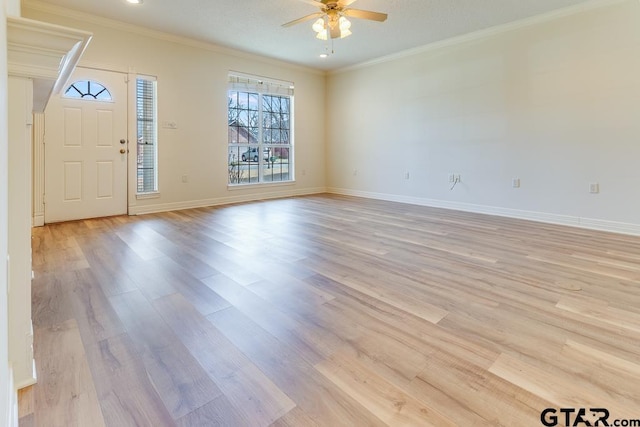 foyer with a ceiling fan, crown molding, light wood-style flooring, and baseboards