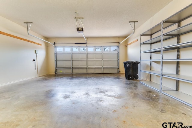 garage featuring baseboards and a garage door opener