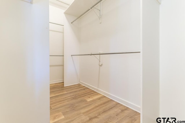 spacious closet with wood finished floors