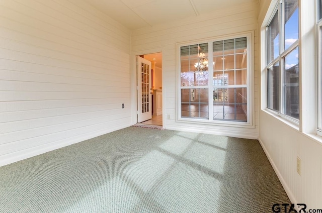 unfurnished sunroom with a notable chandelier