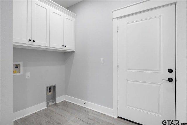 laundry room with cabinets, electric dryer hookup, washer hookup, and light hardwood / wood-style flooring