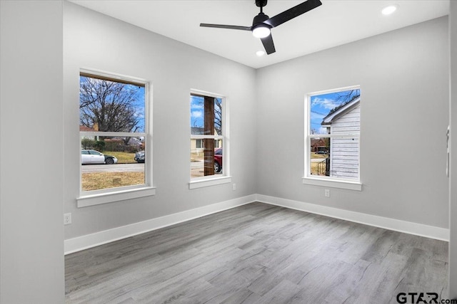 unfurnished room with hardwood / wood-style flooring and ceiling fan