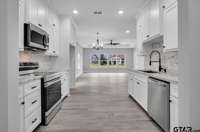 kitchen featuring stainless steel appliances and white cabinets