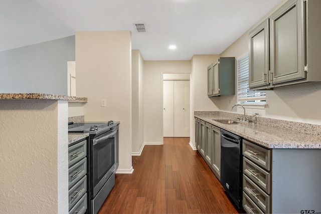 kitchen with dark hardwood / wood-style floors, light stone countertops, stainless steel electric range oven, sink, and dishwasher