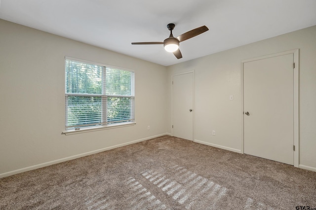 unfurnished bedroom with carpet flooring and ceiling fan