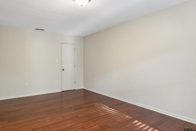 spare room featuring dark hardwood / wood-style flooring