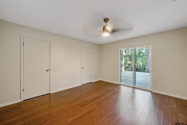 empty room featuring dark hardwood / wood-style flooring and ceiling fan