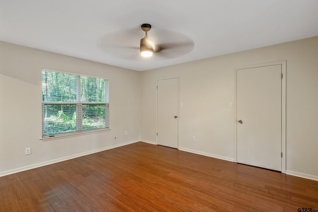 unfurnished bedroom featuring hardwood / wood-style floors and ceiling fan