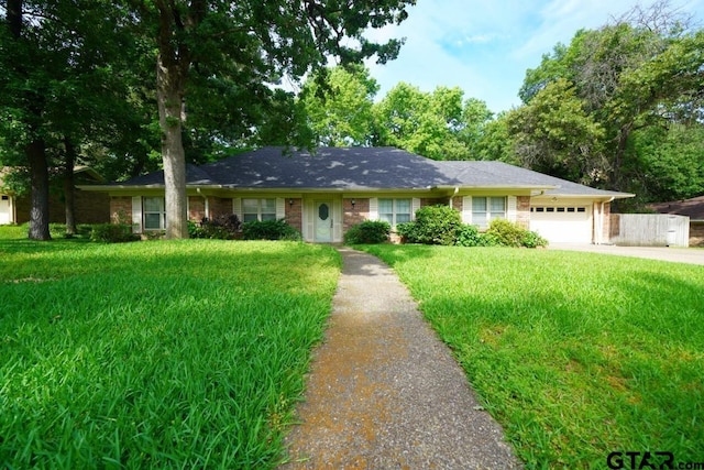 4505 Inverness, Tyler, TX 75703 - ranch-style house featuring driveway, an attached garage, and a front lawn