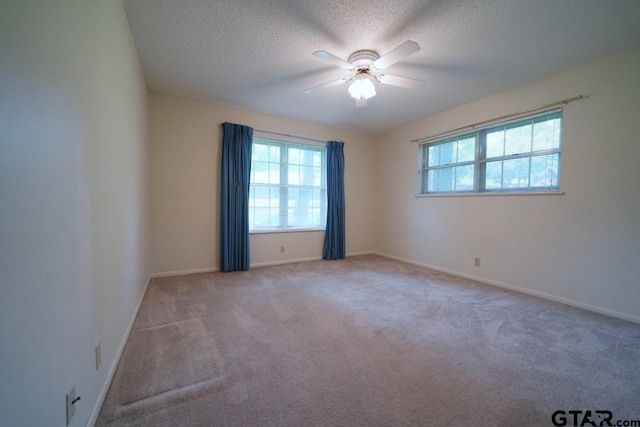 4505 Inverness, Tyler, TX 75703 - empty room featuring a ceiling fan, carpet, a textured ceiling, and baseboards