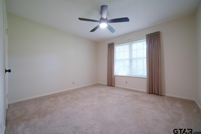 4505 Inverness, Tyler, TX 75703 - empty room featuring light carpet, baseboards, and ceiling fan