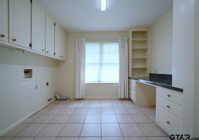 4505 Inverness, Tyler, TX 75703 - laundry area featuring hookup for an electric dryer, washer hookup, cabinet space, a textured ceiling, and light tile patterned floors