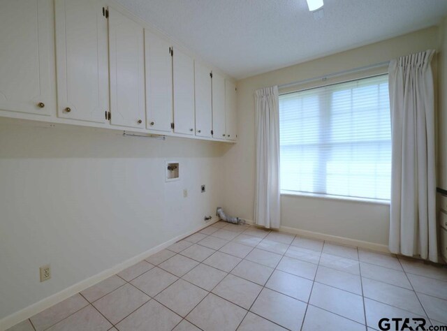 4505 Inverness, Tyler, TX 75703 - laundry room featuring hookup for a washing machine, hookup for an electric dryer, baseboards, light tile patterned floors, and cabinet space