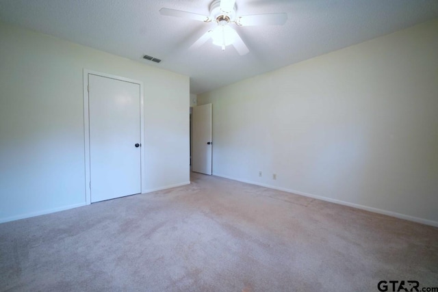 4505 Inverness, Tyler, TX 75703 - unfurnished bedroom featuring light carpet, baseboards, a ceiling fan, and a closet