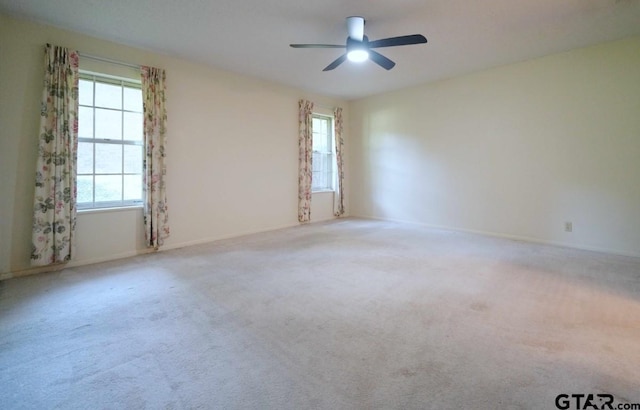 4505 Inverness, Tyler, TX 75703 - unfurnished room featuring plenty of natural light, a ceiling fan, carpet floors, and baseboards