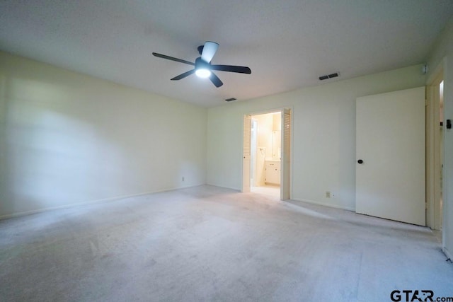 4505 Inverness, Tyler, TX 75703 - unfurnished bedroom featuring light colored carpet, ceiling fan, ensuite bathroom, and baseboards