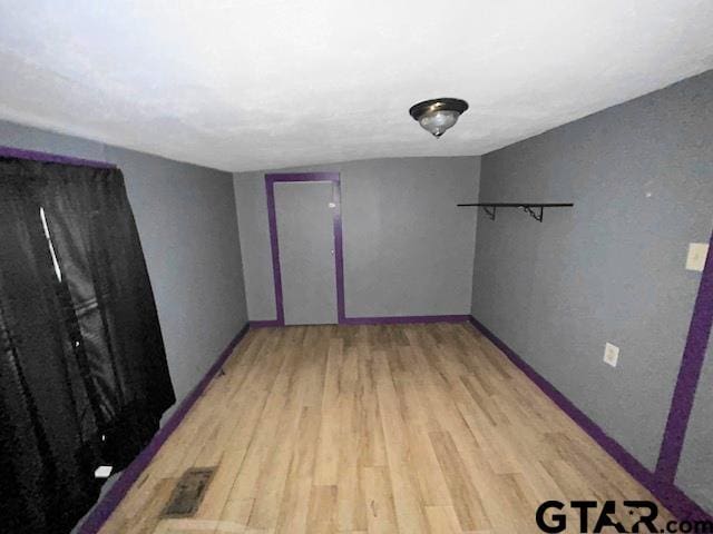 empty room with hardwood / wood-style floors