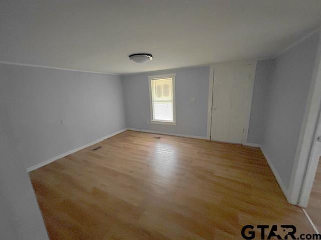 empty room with light hardwood / wood-style floors