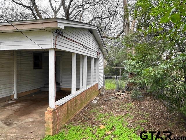 view of side of home featuring a carport