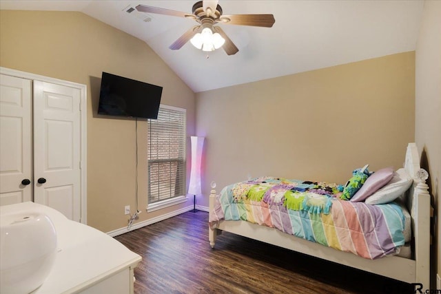 bedroom featuring sink, dark wood-type flooring, ceiling fan, vaulted ceiling, and a closet