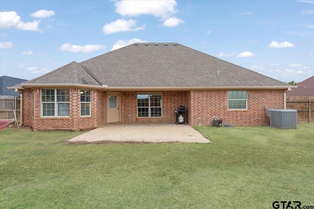 back of property with a yard, central AC unit, and a patio area