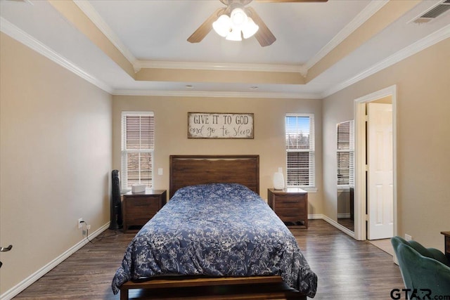 bedroom with crown molding, ceiling fan, and a tray ceiling