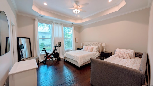 bedroom with visible vents, crown molding, dark wood-style flooring, recessed lighting, and a tray ceiling